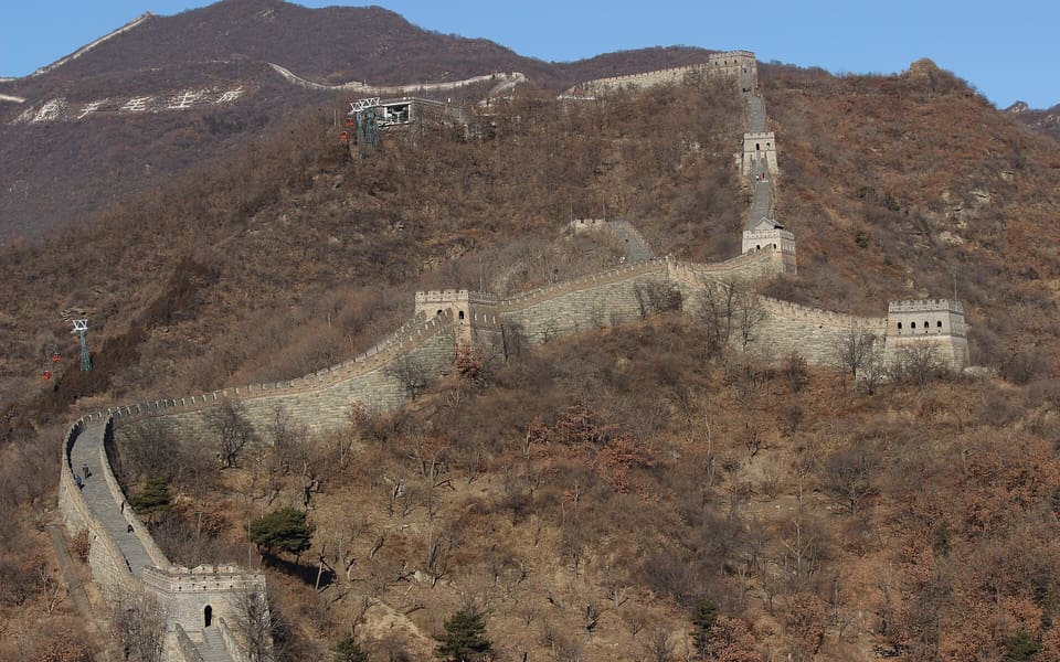 Watchtowers and stone ramparts follow the winter mountain ridges at Mutianyu
