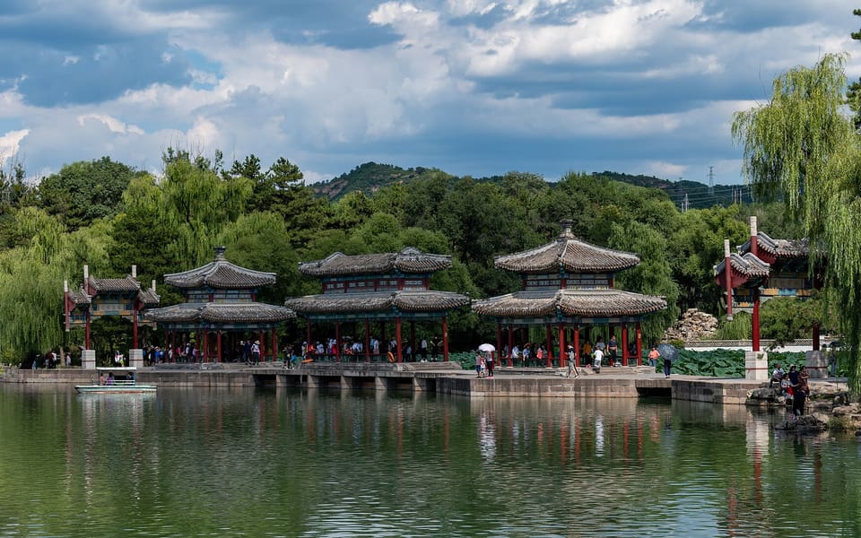 Lake pavilions and willow trees reflect in the water at Chengde Mountain Resort