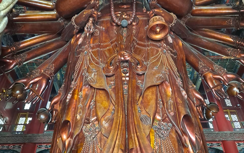 Monumental wooden Thousand-Armed Guanyin fills the main hall at Chengde's Puning Temple