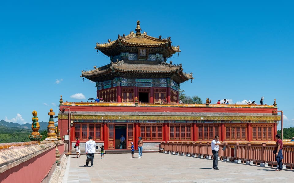 The golden-roofed Wanfaguiyi hall rises above red terraces at Putuo Zongcheng Temple