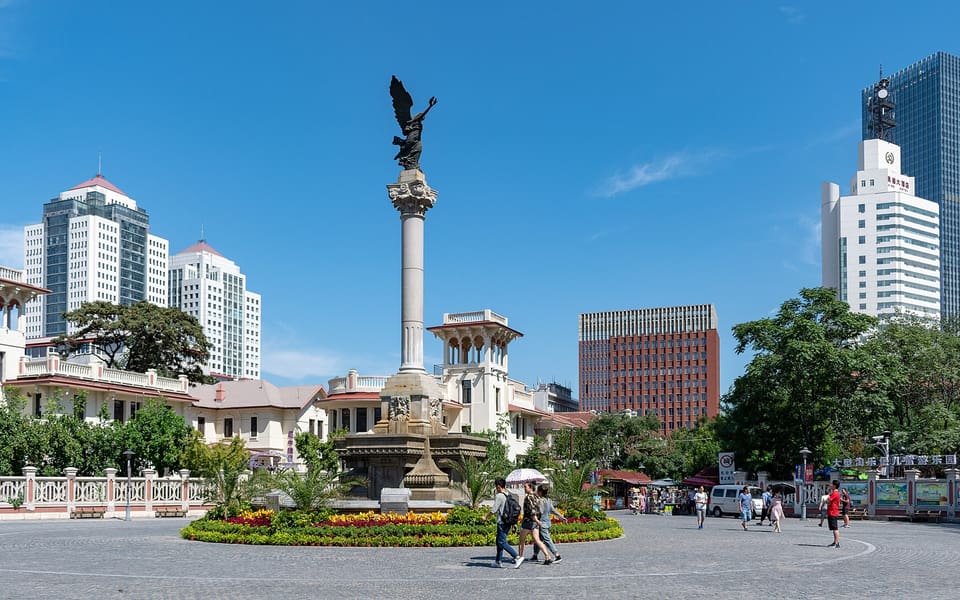 Marco Polo Square's winged column stands among former concession villas and modern towers in Tianjin