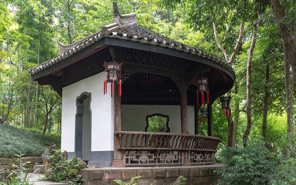A traditional tiled garden pavilion amid leafy trees at Du Fu Thatched Cottage in Chengdu