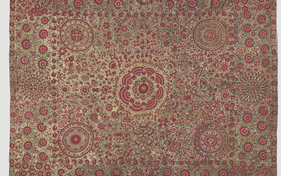 A densely embroidered red and green nineteenth-century silk suzani from the China National Silk Museum collection