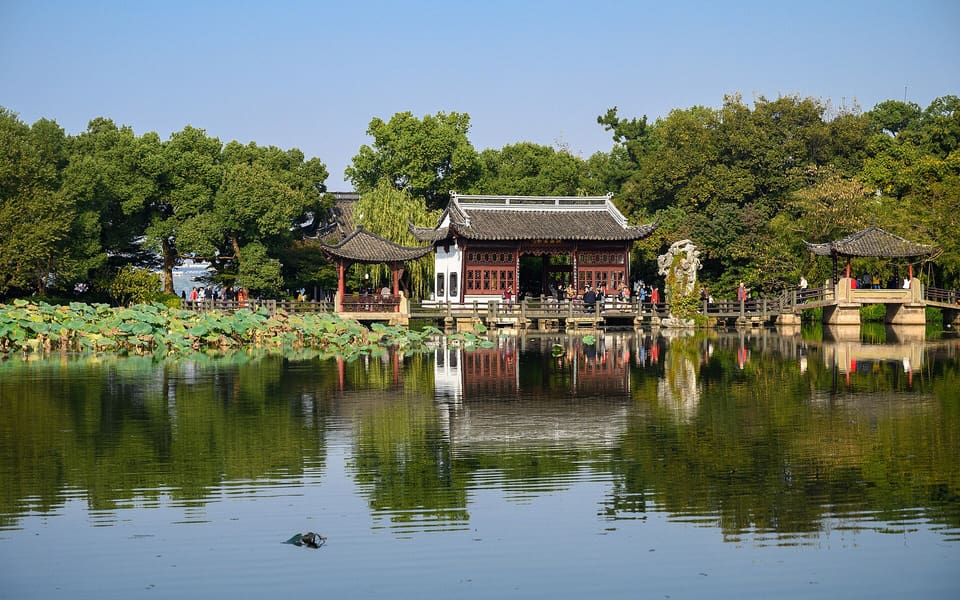 Lotus leaves, waterside pavilions and their reflections at Three Pools Mirroring the Moon on West Lake