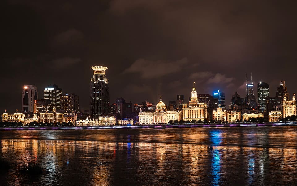 The historic Bund buildings illuminated at night across the Huangpu River in Shanghai