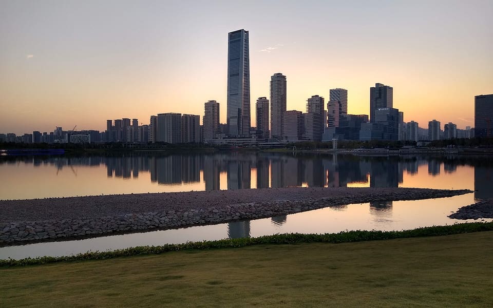 Sunset reflected across the water toward the skyline from Shenzhen Bay Park