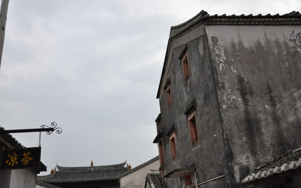 Weathered grey-walled historic houses inside Dapeng Fortress in Shenzhen