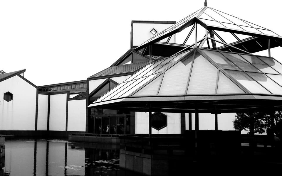 Geometric black-and-white architecture of Suzhou Museum's I. M. Pei-designed Main Building reflected in a courtyard pool