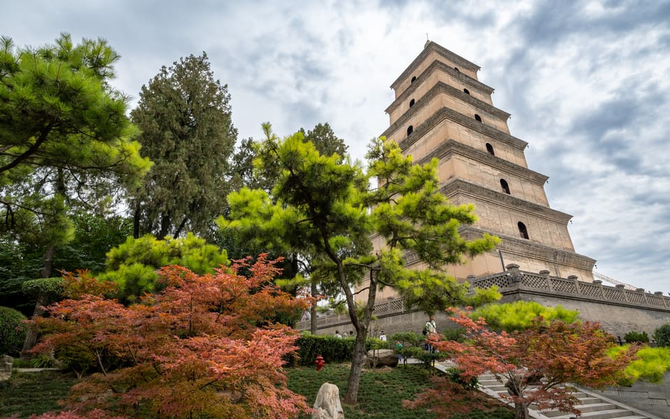 Giant Wild Goose Pagoda rising above pine trees and autumn foliage in Xi'an