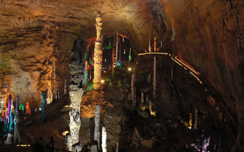 Illuminated stalactites and stone columns inside Yellow Dragon Cave near Zhangjiajie