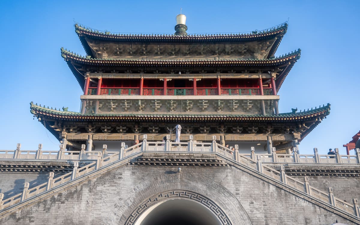 Xi'an Bell Tower rising above its stone base beneath a clear blue sky
